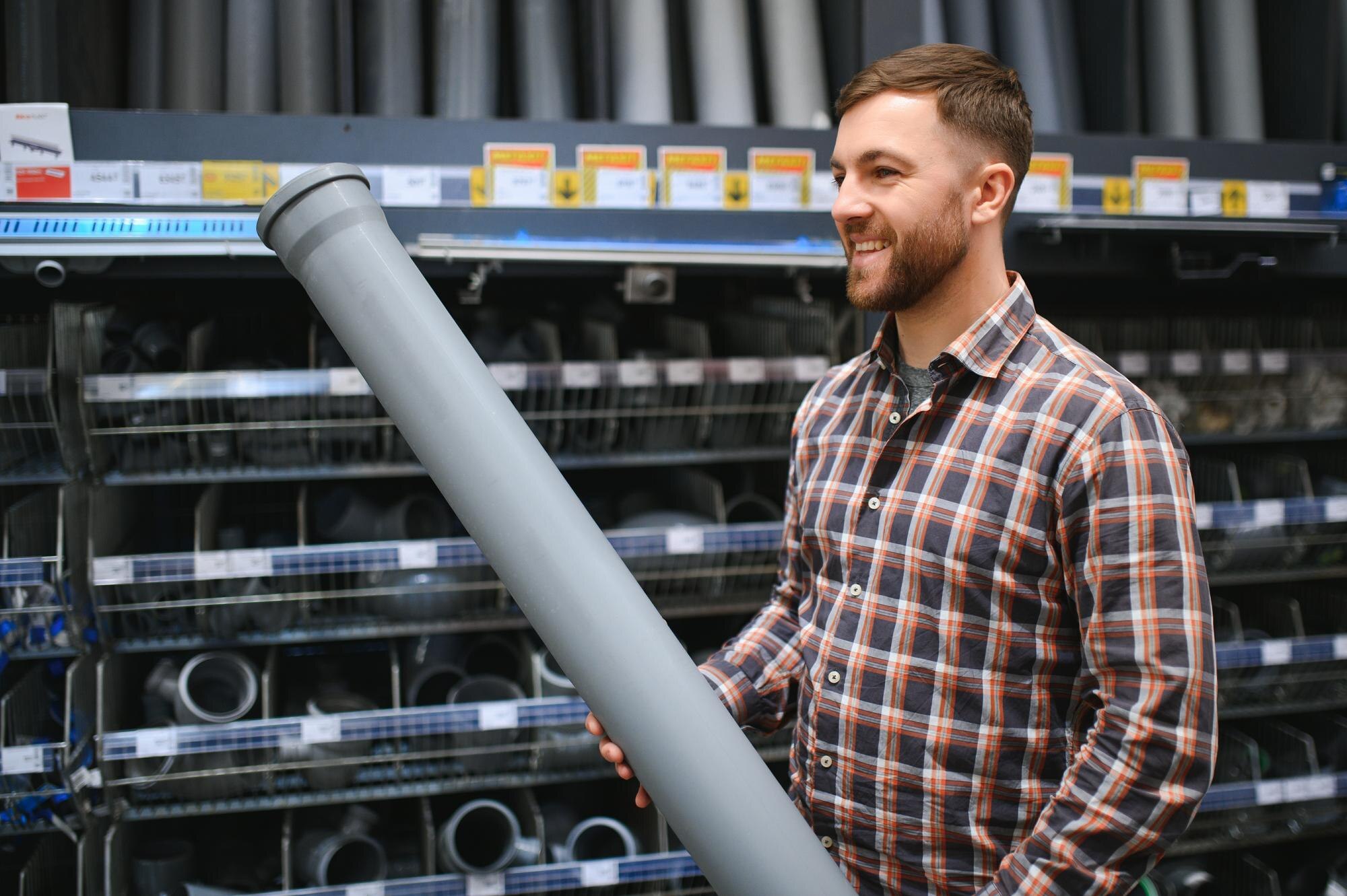 handsome-workman-choosing-sewer-pipes-standing-near-showcase-plumbing-shop-255667-78177.jpg
