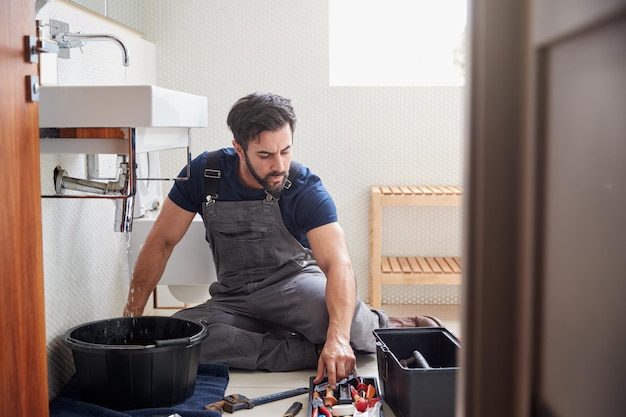 male-plumber-working-fix-leaking-sink-home-bathroom_625516-1826.jpg
