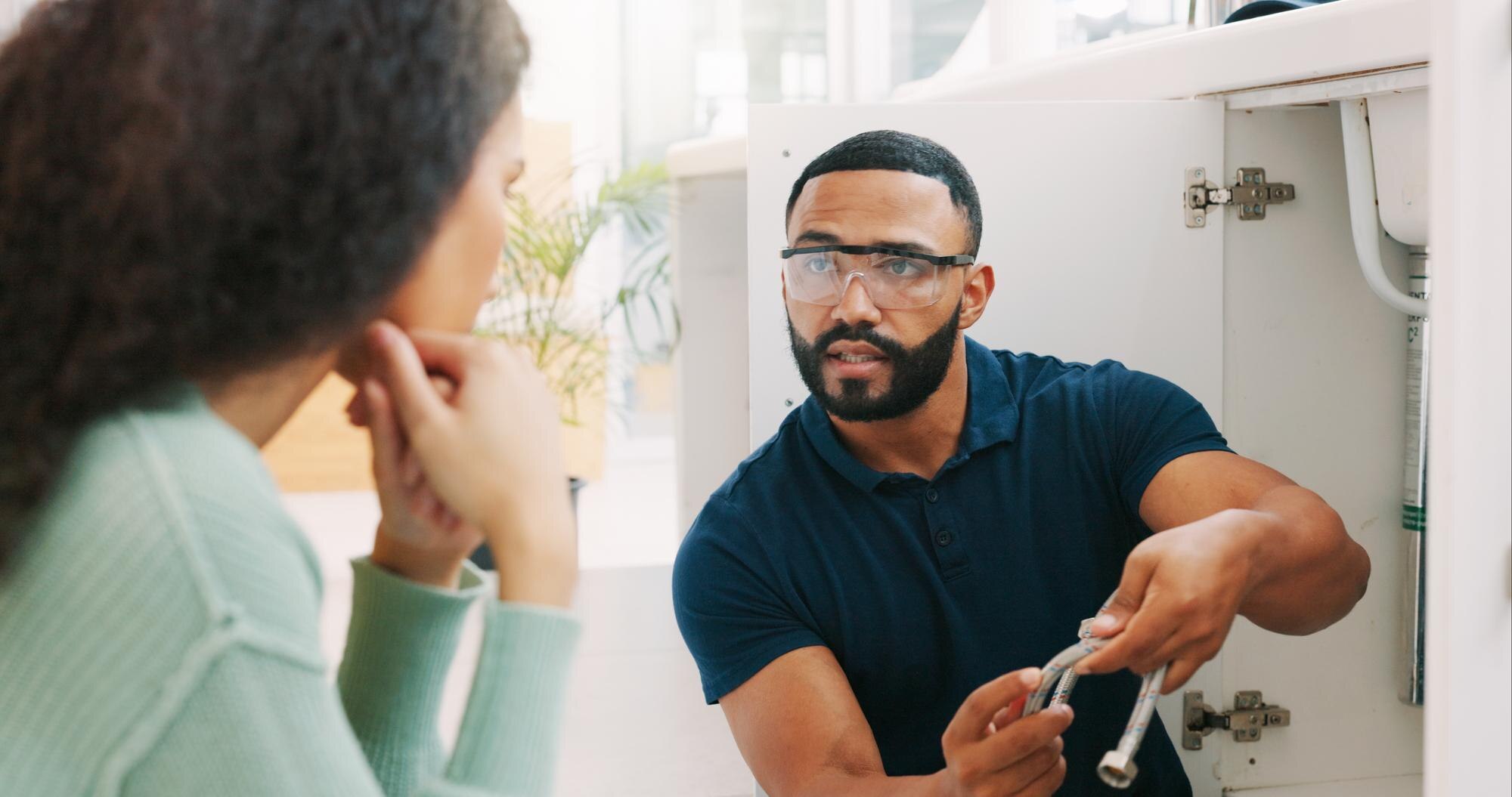 plumber-black-man-woman-maintenance-talk-kitchen-sink-pipe-with-customer-support-home-entrepreneur-h.jpg