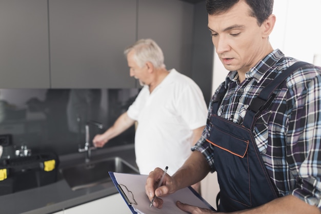 two-men-plumbers-are-standing-kitchen_85574-7130.jpg